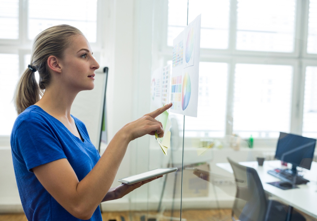 female-graphic-designer-looking-color-chart-while-holding-digital-tablet (1).jpg